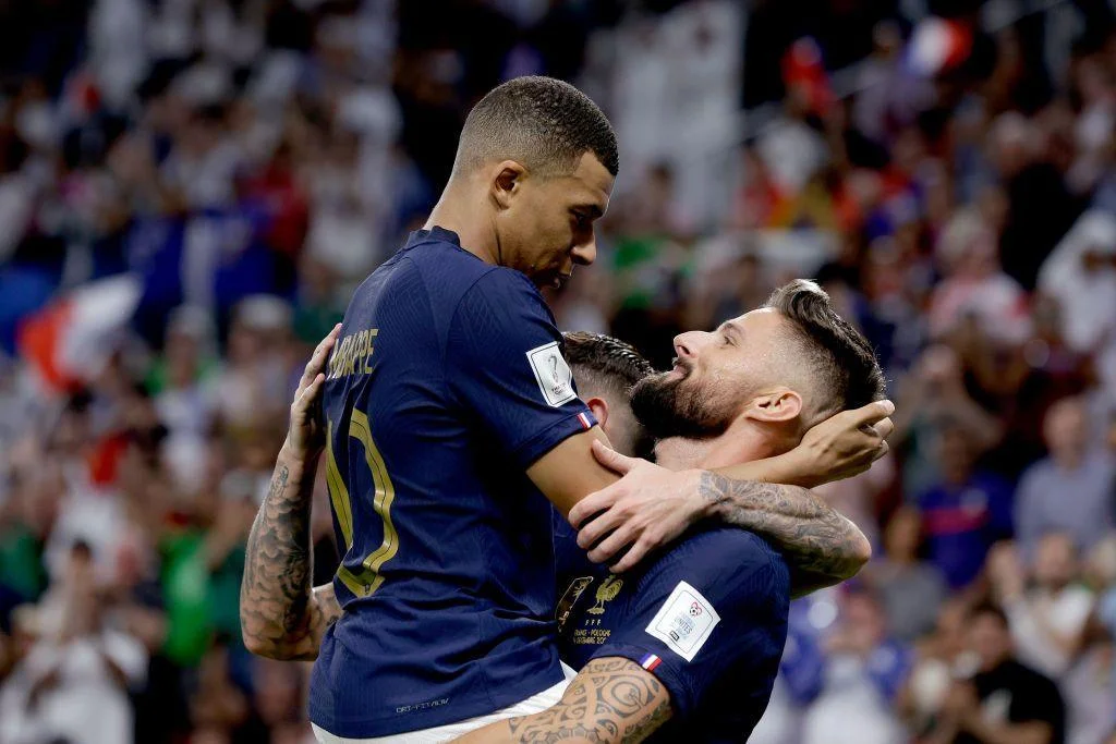 Kylian Mbappe (left) celebrates with Olivier Giroud after Giroud's record-breaking goal against Poland in 2022