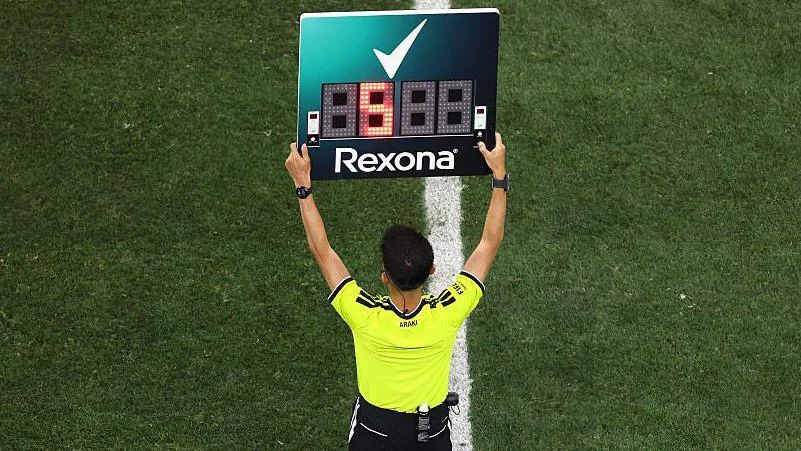 The fourth official holds up the substitution board during the Fifa World Cup match between Iran and New Zealand