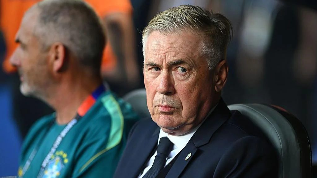 Brazil head coach Carlo Ancelotti sat in the dugout and looking to his left with a slight raised eyebrow before their World Cup match against Morocco