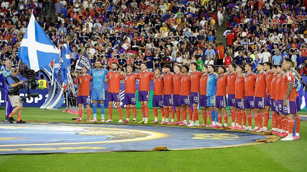 Scotland players prepare to sing the national anthem before their game against Haiti