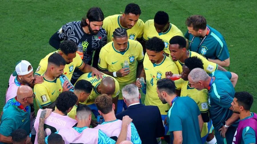 Carlo Ancelotti delivers instructions to his Brazil players during a hydration break