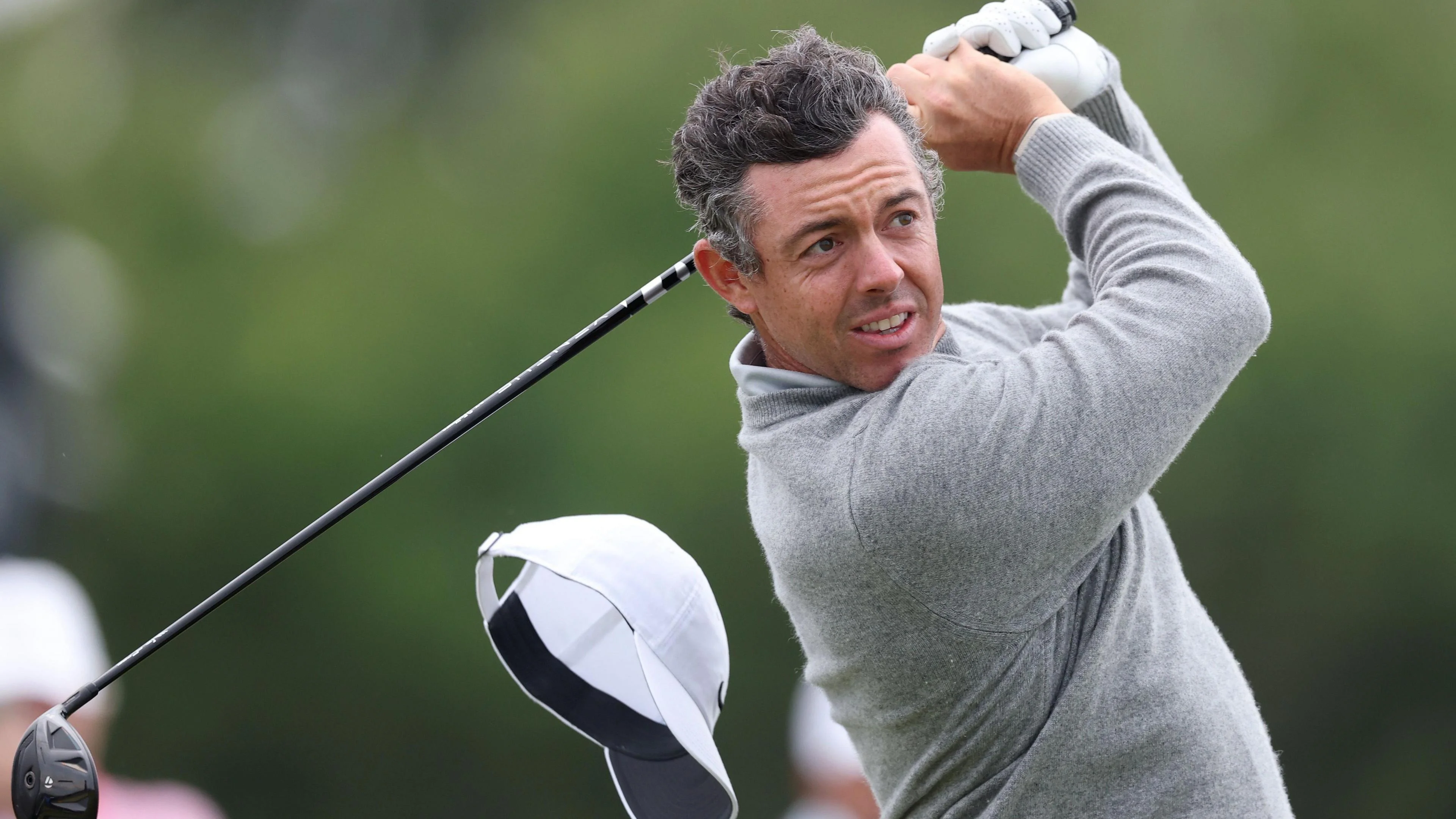 Rory McIlroy's cap flies off on the 13th hole