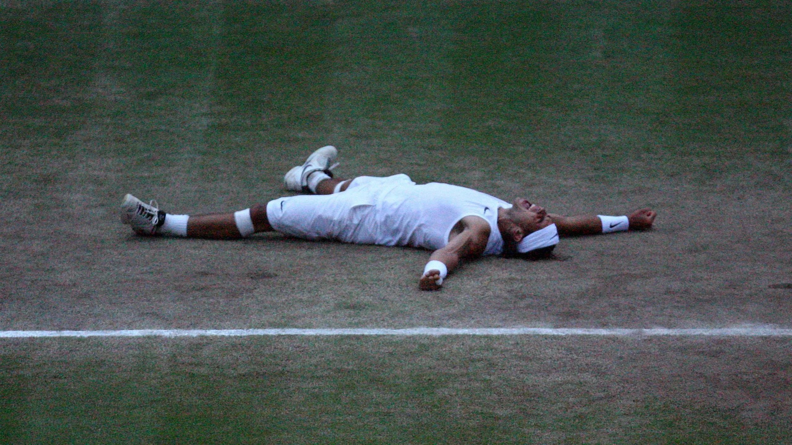 Rafael Nadal falls to the ground after winning Wimbledon in 2008
