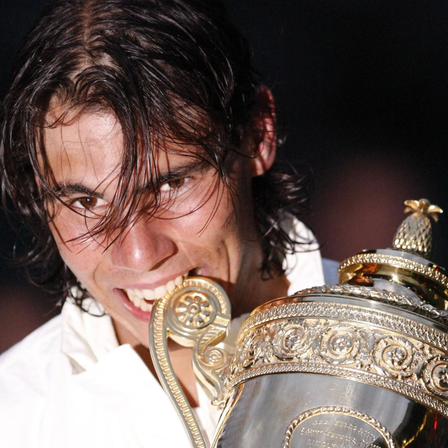 Rafael Nadal bites the Wimbledon trophy