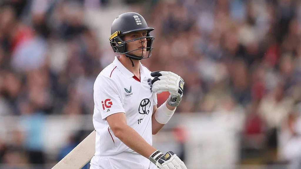 Jamie Smith carries his bat under his arm while playing for England