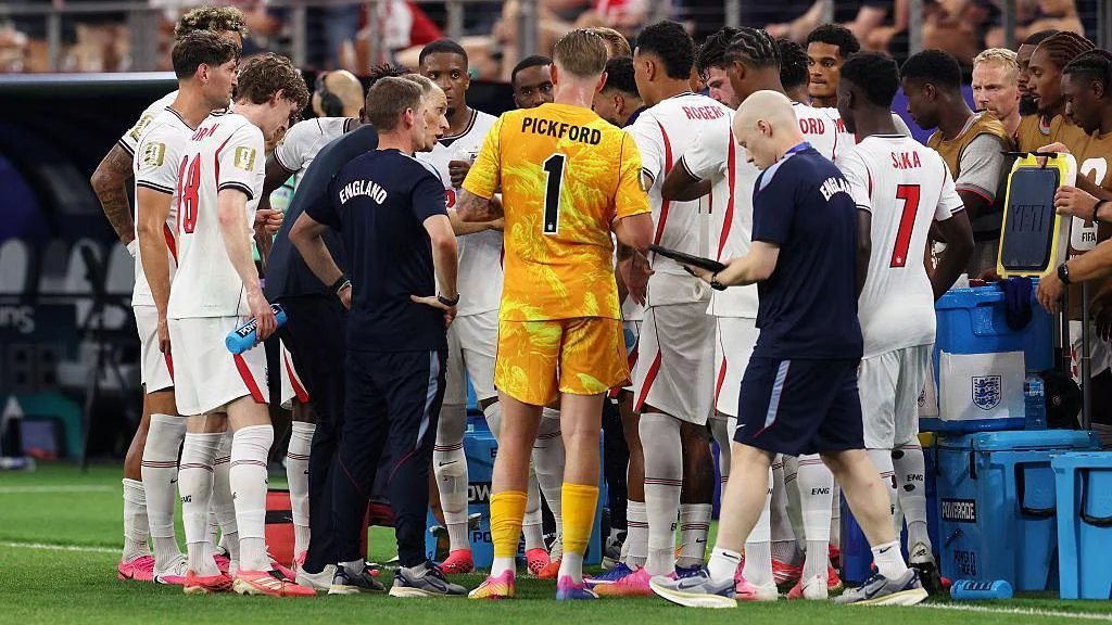 England players gather on the touchline for a hydration break during the 4-2 victory over Croatia at the 2026 FIFA World Cup in  Dallas, Texas