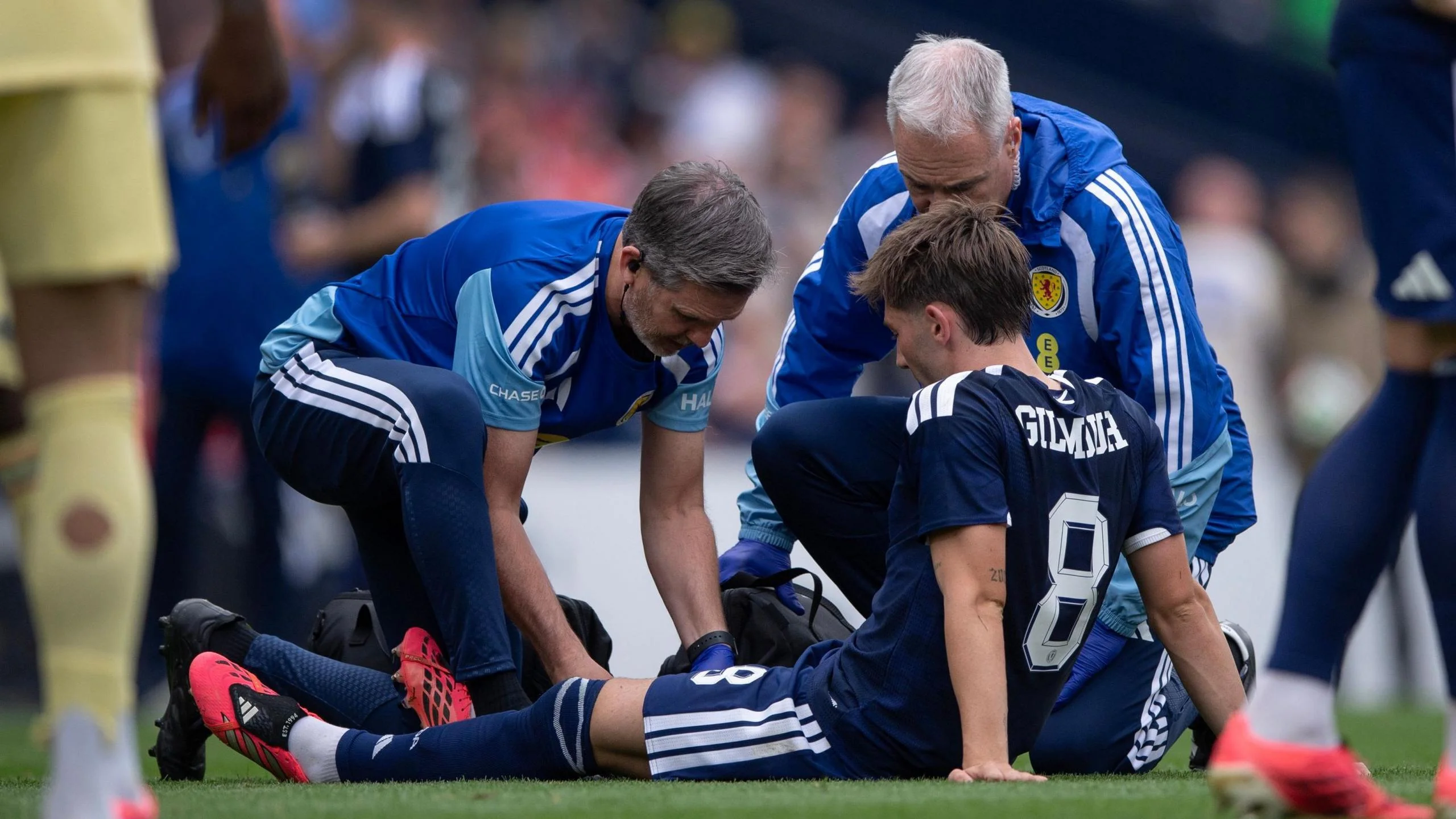 Billy Gilmour receives treatment from physios during Scotland's friendly win over Curacao
